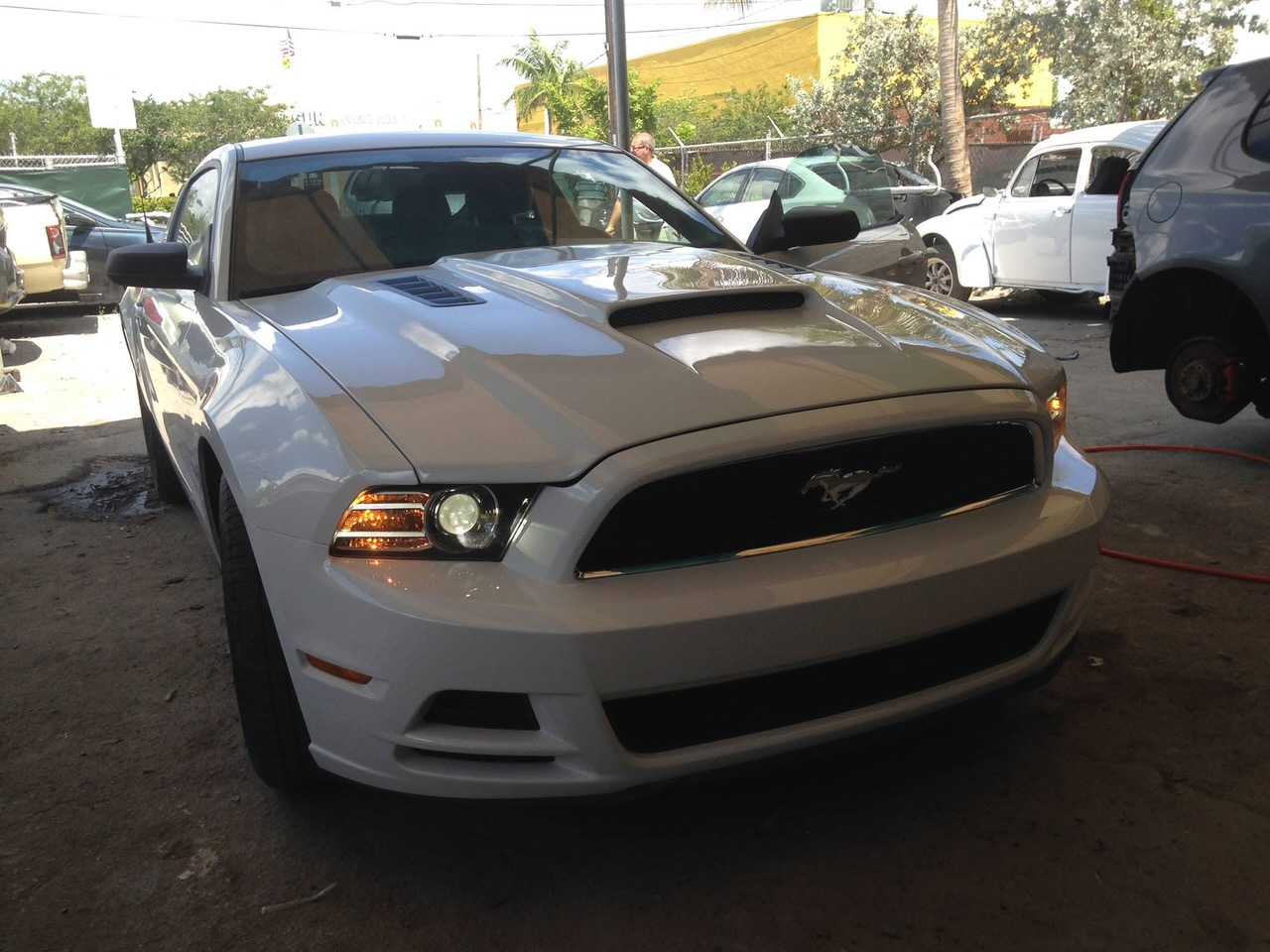 Front-end collision, white Mustang — after repair