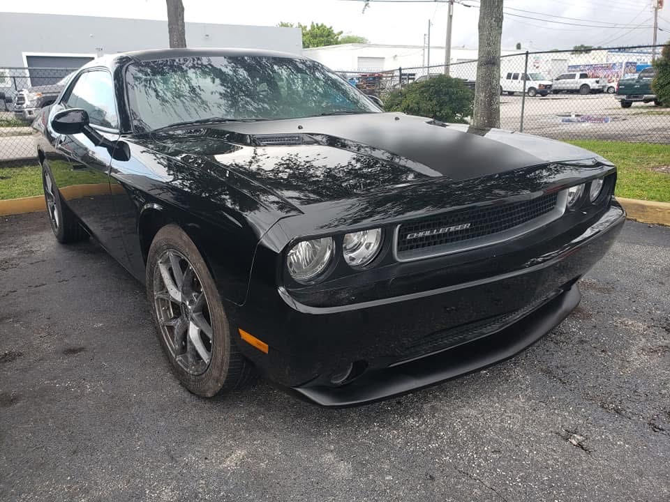 Roof and glass damage, black Challenger — after repair